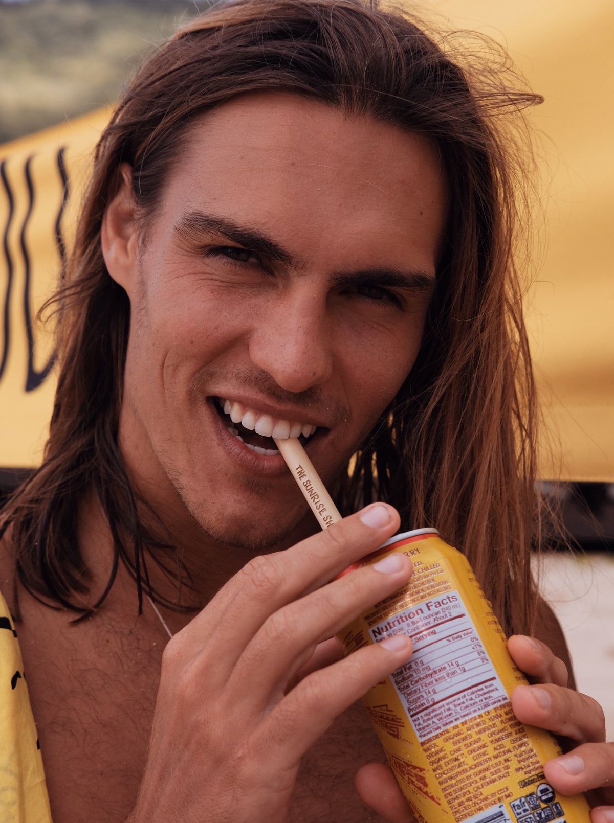man drinking from a bamboo straw