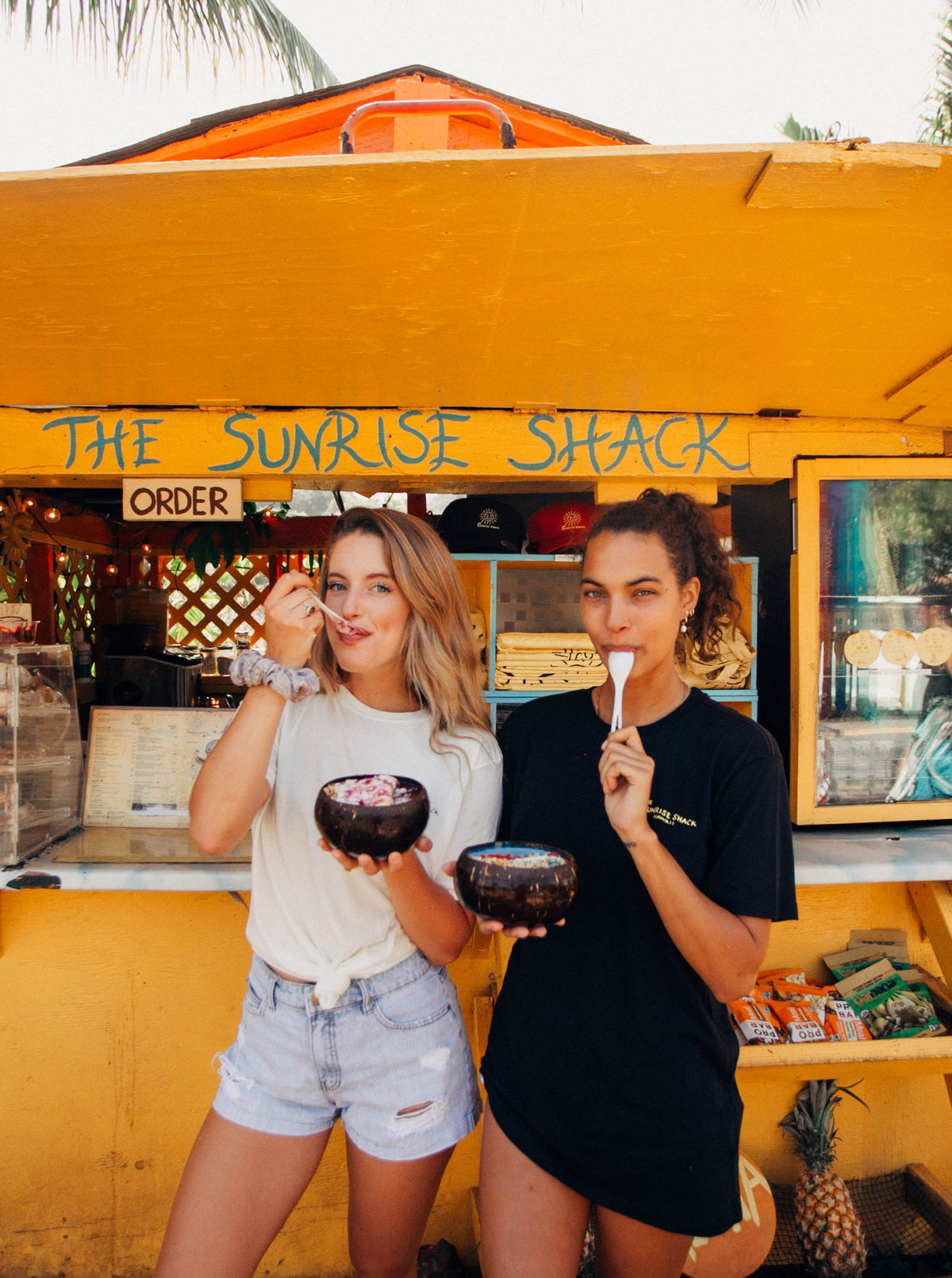 two friends with coconut bowls